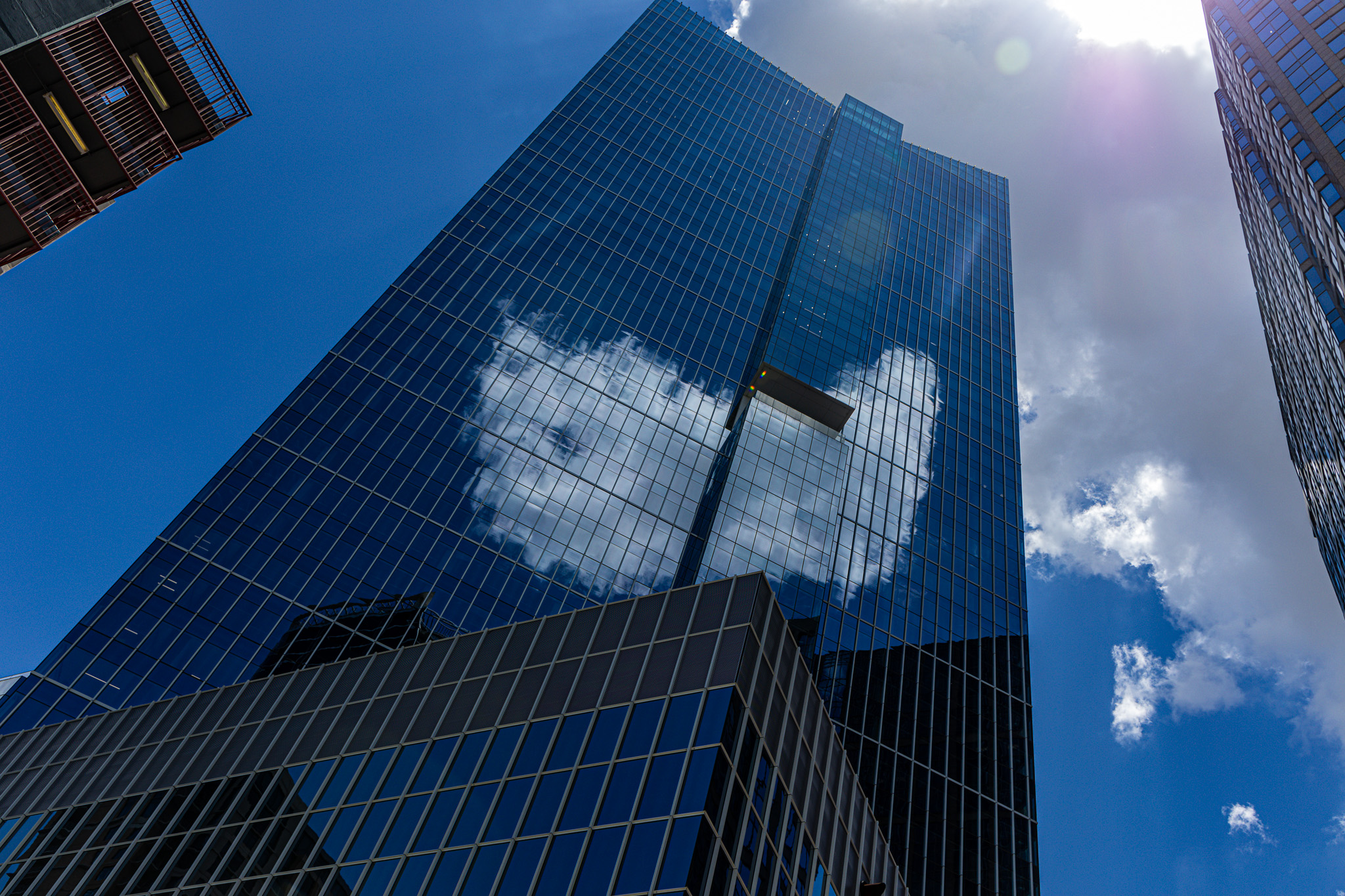 Clouds reflected in a glass office tower in downtown Houston