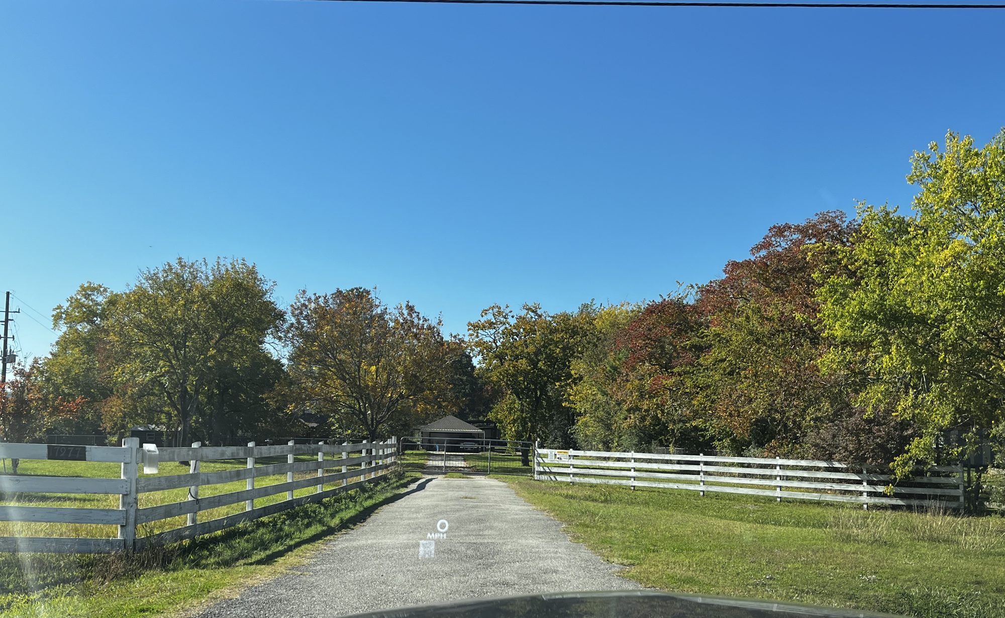 Country lane with white ranch fences in the Klein Texas area
