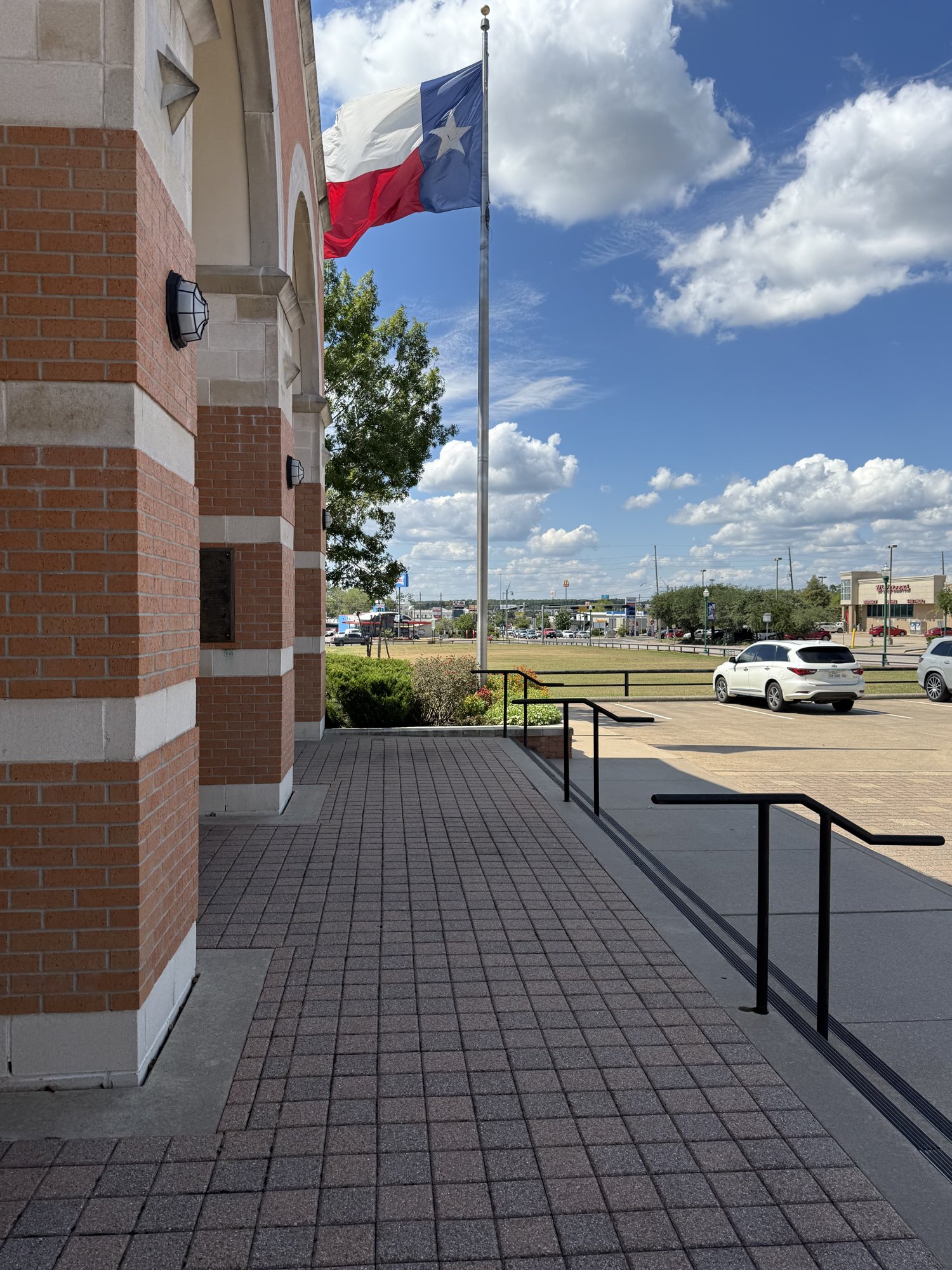 Texas flag flying outside a brick building in Conroe, Texas